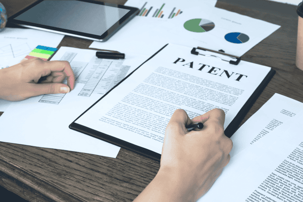 Business woman signs a patent. Intellectual property protection concept. Patent attorney.