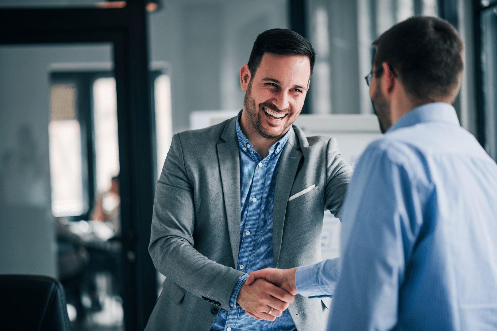 Portrait of cheerful young manager handshake with new employee Entrepre
