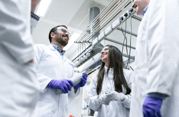 Chemical-engineers-talk-in-laboratory