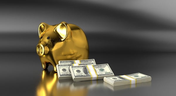 golden piggy bank with bills