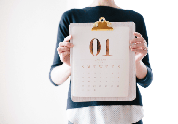 person holding calendar at January