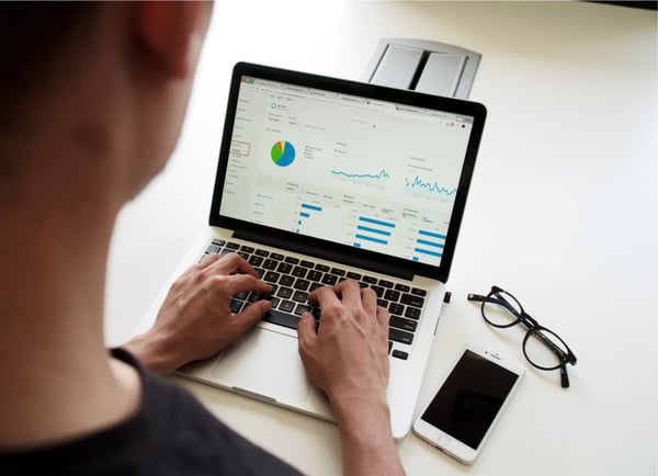 person using MacBook Pro budget