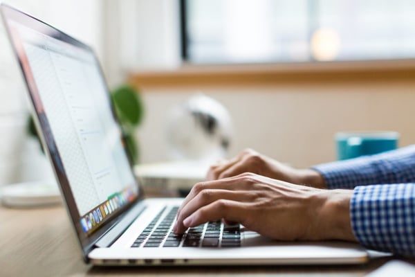 person using macbook hands