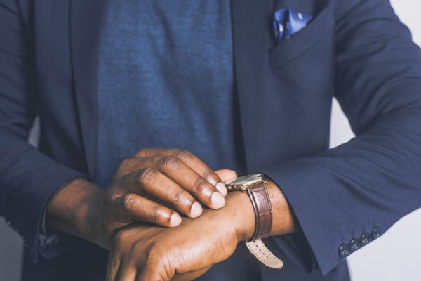 standing man looking at as his watch