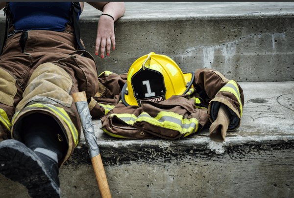 yellow hard hat woman sitting down during emergency