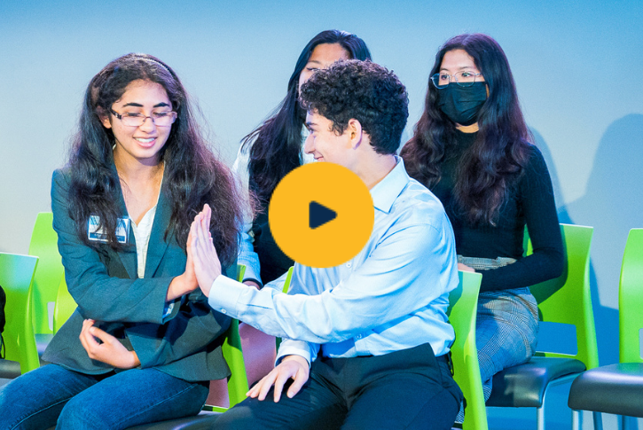 Students high-fiving while smiling